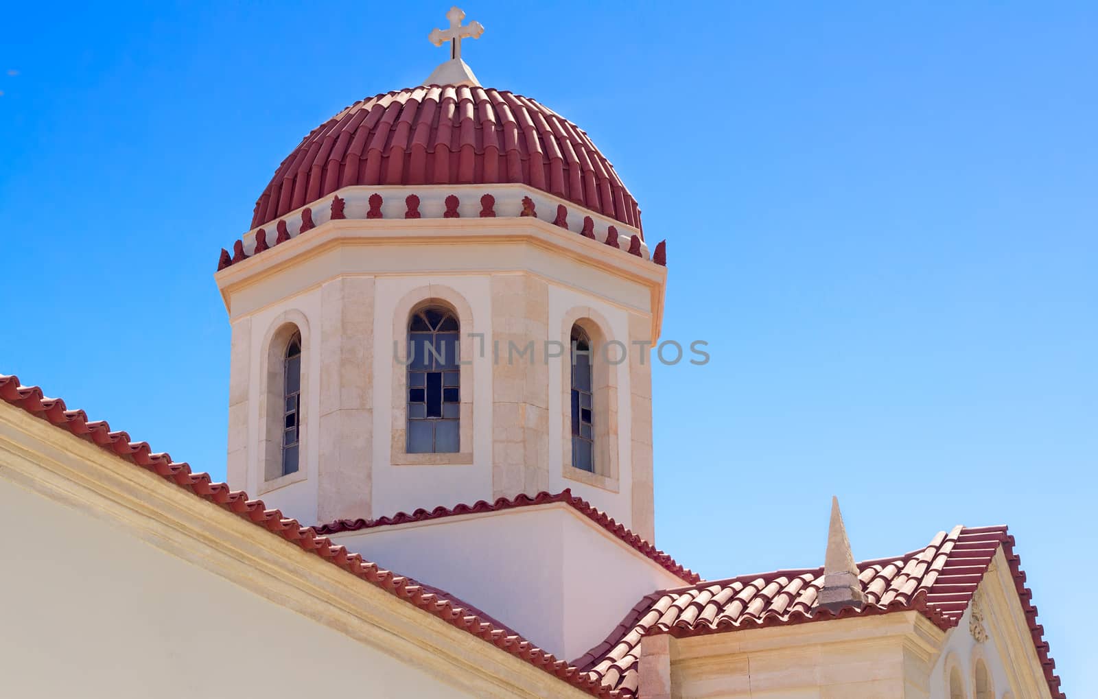 Dome and the top part of church of Saint Varvara on the island of Crete. Are presented against the blue sky.