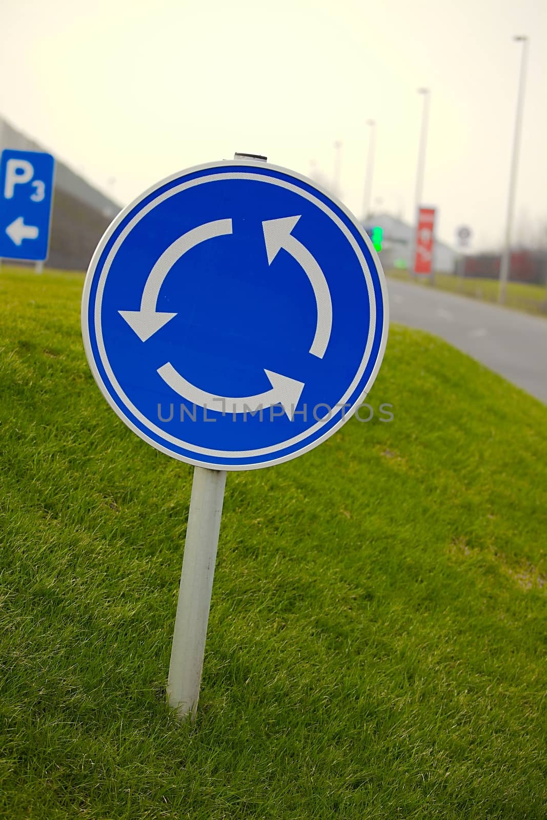 Roundabout traffic sign over grass