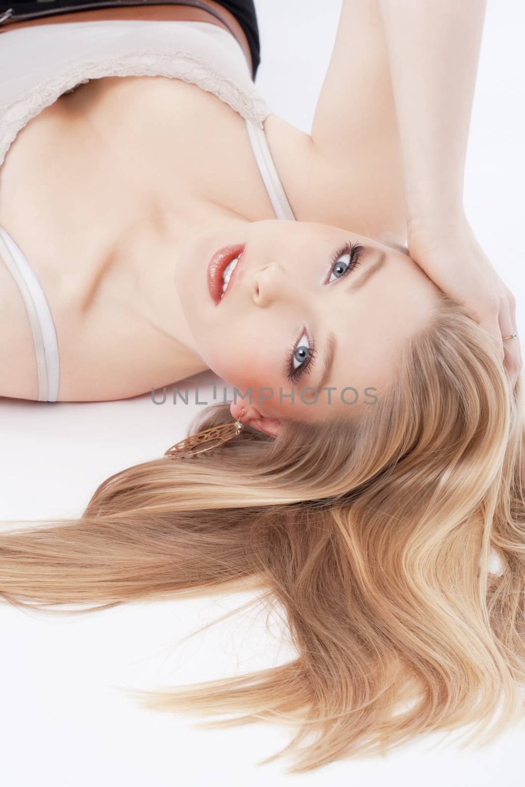 beautiful young woman lying down, looking- isolated on white