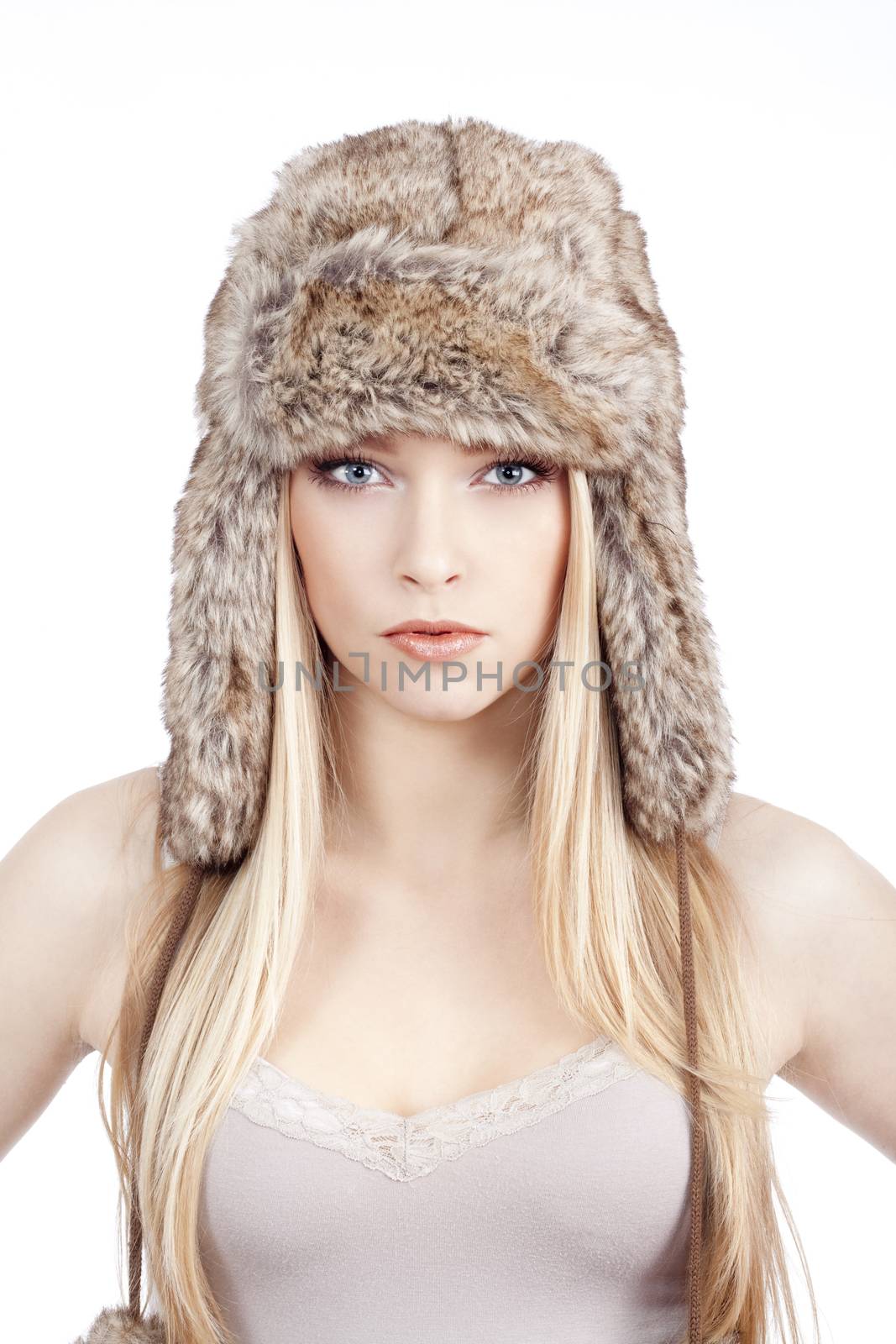 beautiful blond girl with blue eyes in fur hat - isolated on white