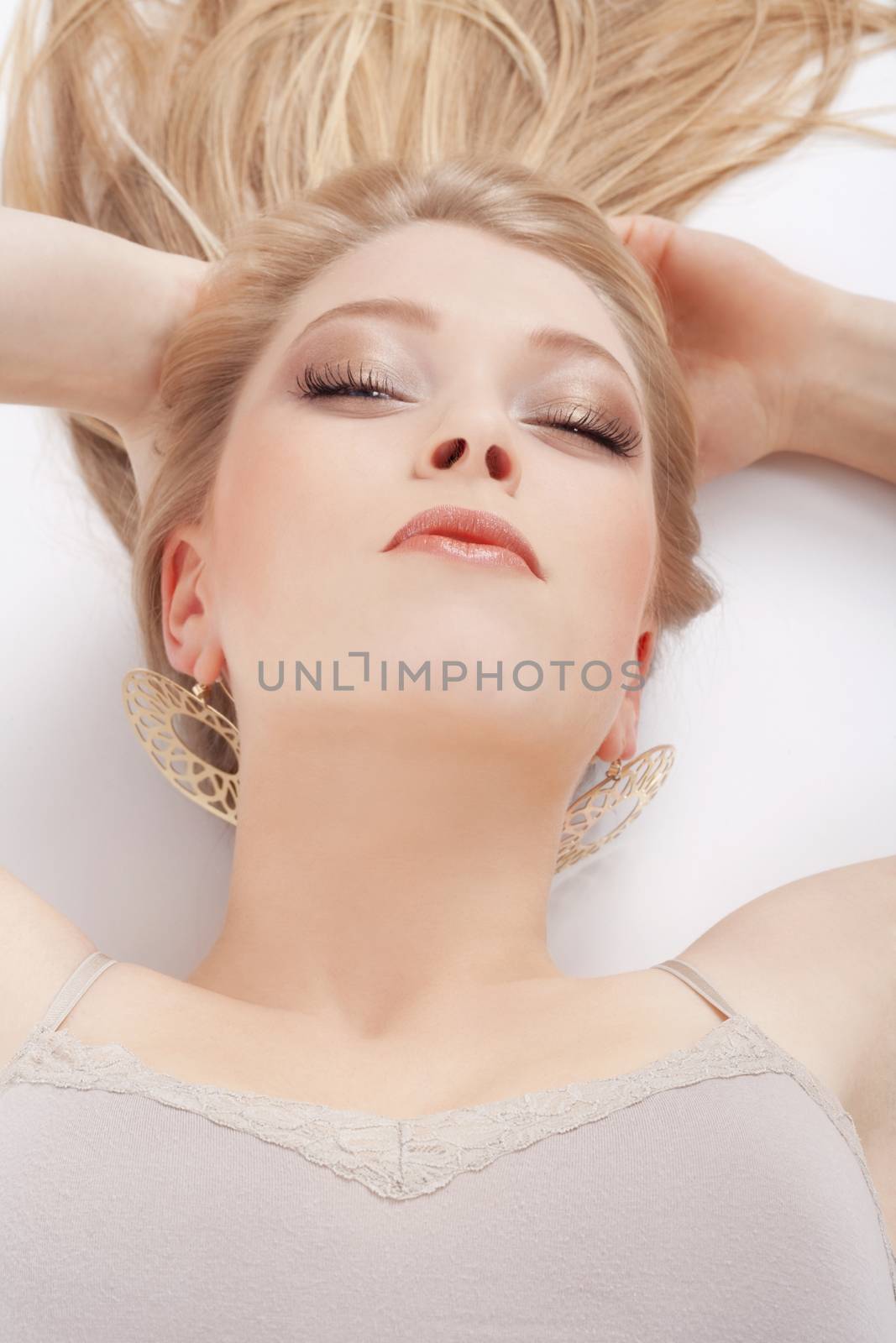 beautiful young woman lying down, looking- isolated on white