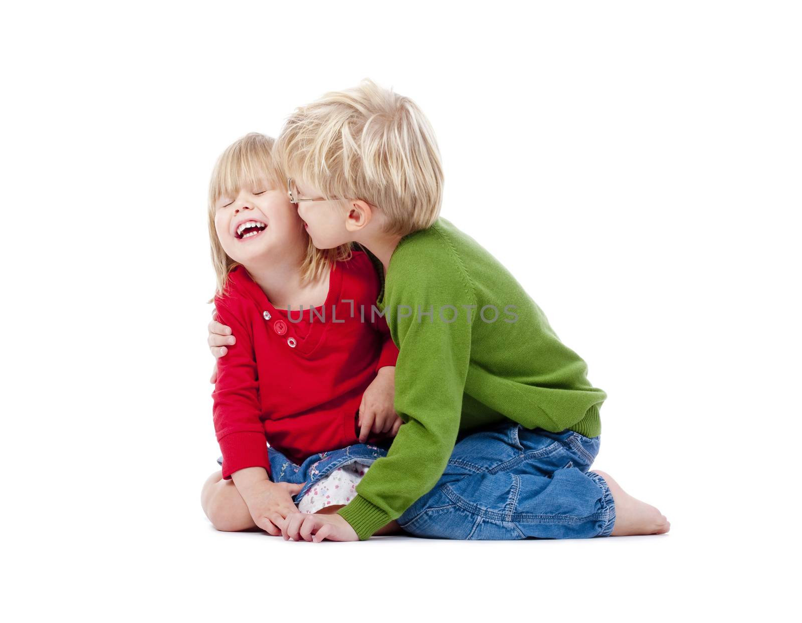 two young siblings fooling around with each other - isolated on white