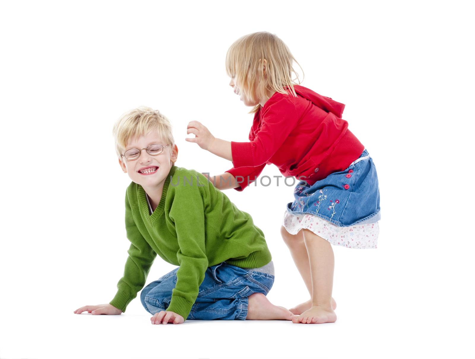 two young siblings fooling around with each other - isolated on white