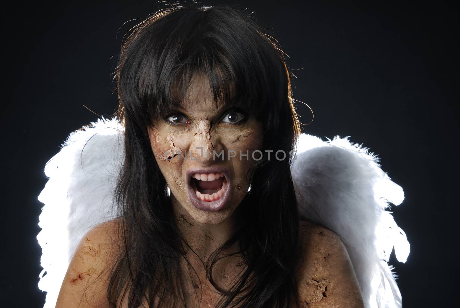 Devil with angelic wings and blood in mouth