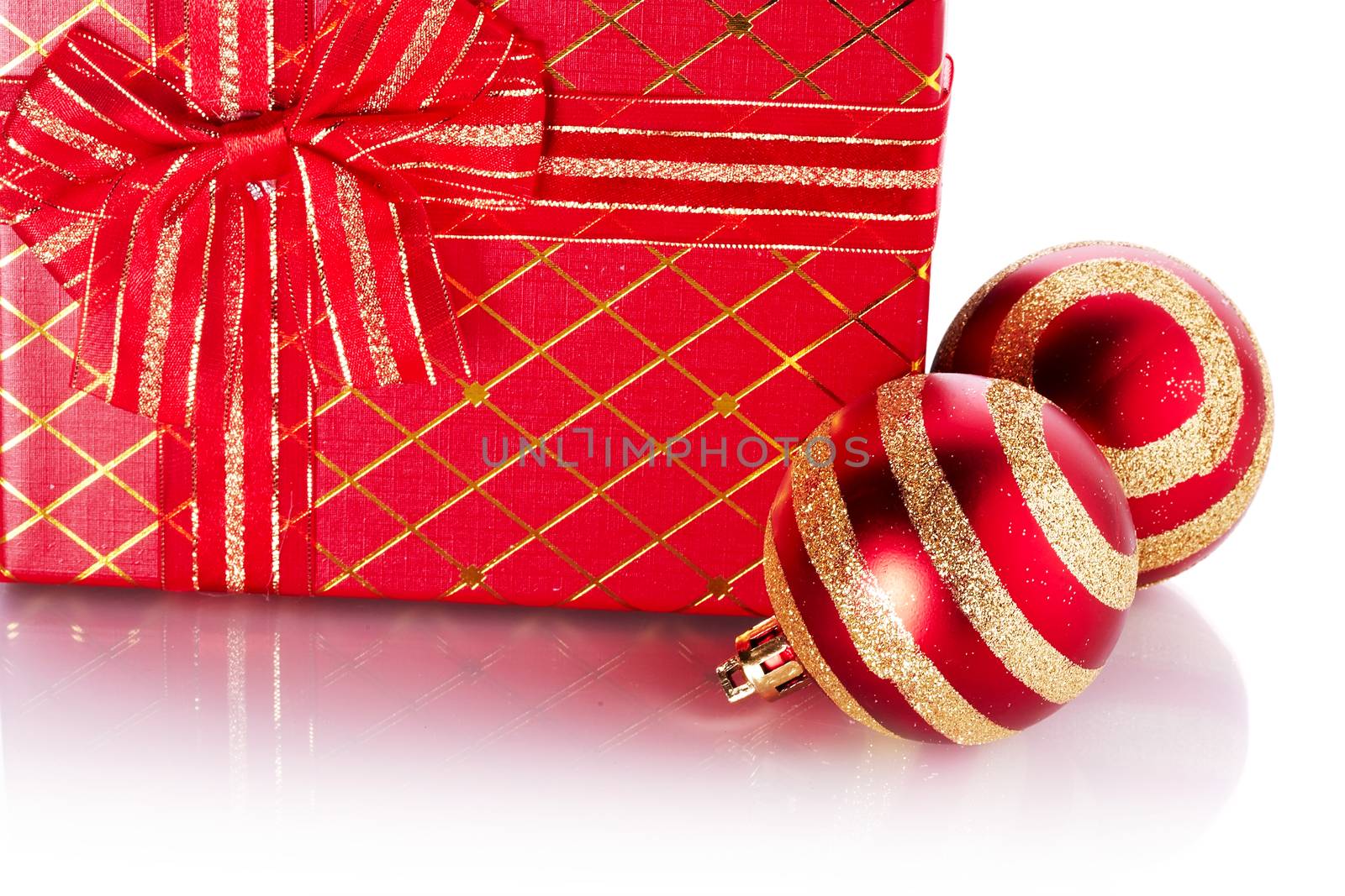 New Year's striped balls and gift. Gift box and Christmas balls. New Year's red balls. Christmas balls. Christmas tree decorations. Christmas jewelry.