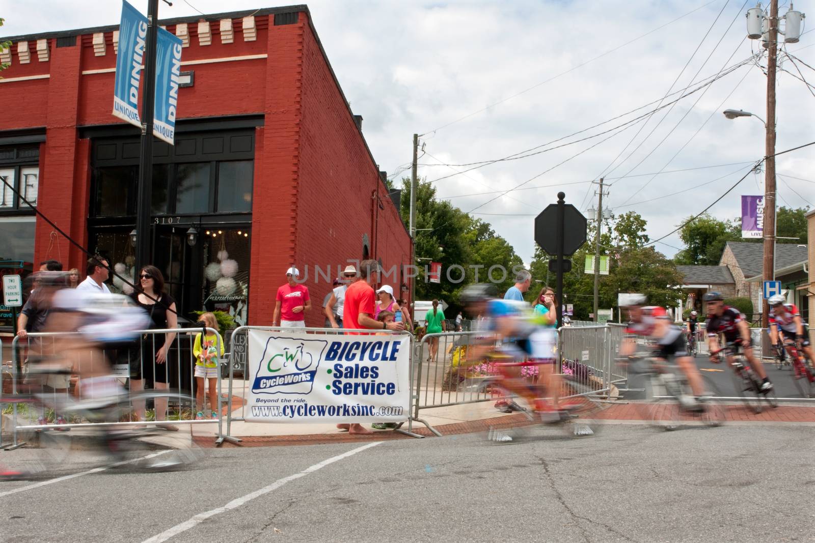 Group Of Cyclists Motion Blur In Turn Of Bike Race by BluIz60