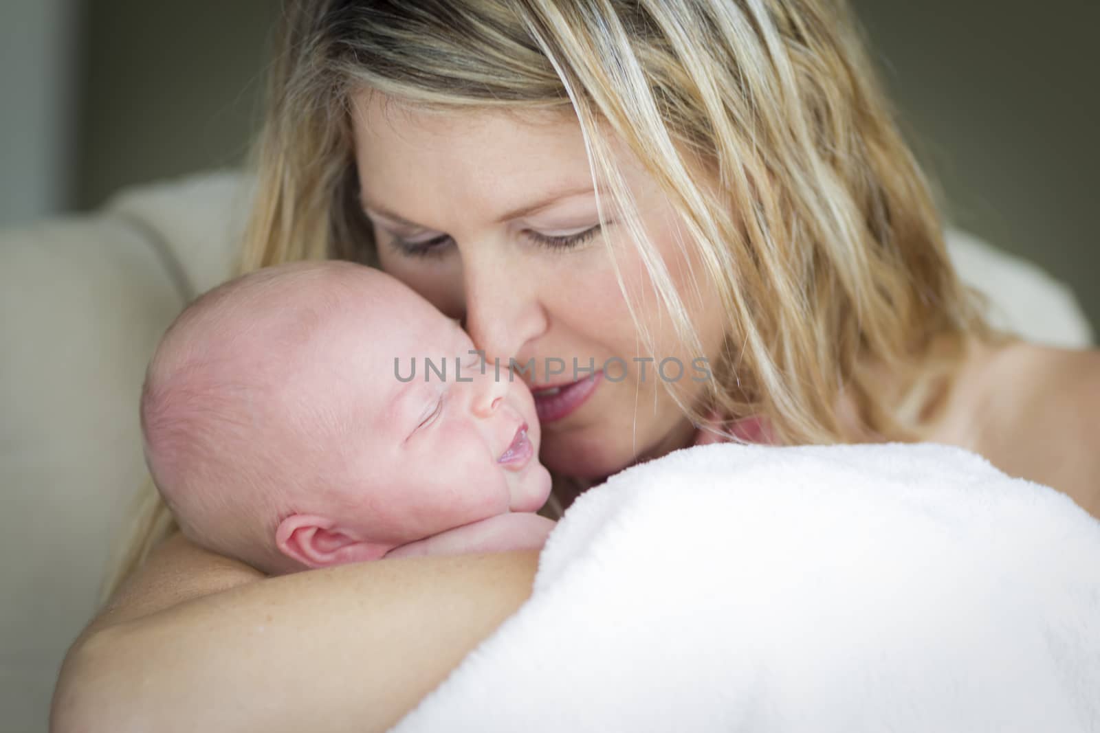 Young Caucasian Beautiful Mother Holding Her Precious Newborn Baby Girl.