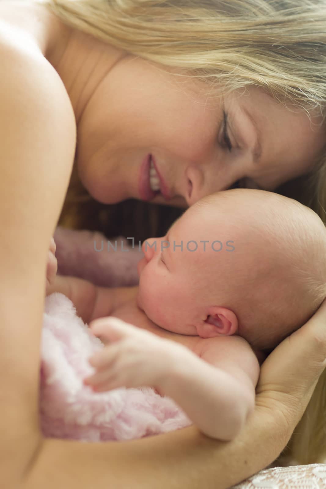 Young Caucasian Beautiful Mother Holding Her Precious Newborn Baby Girl.