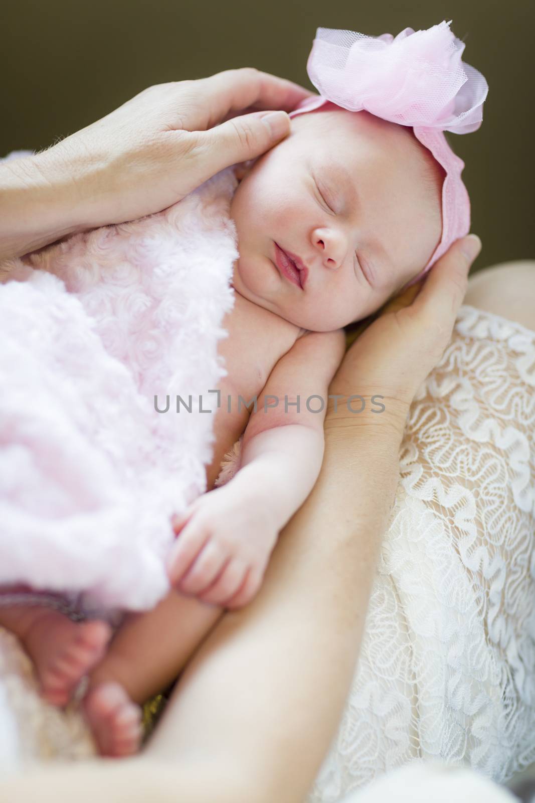 Gentle Hands of Mother Holding Her Precious Newborn Baby Girl.