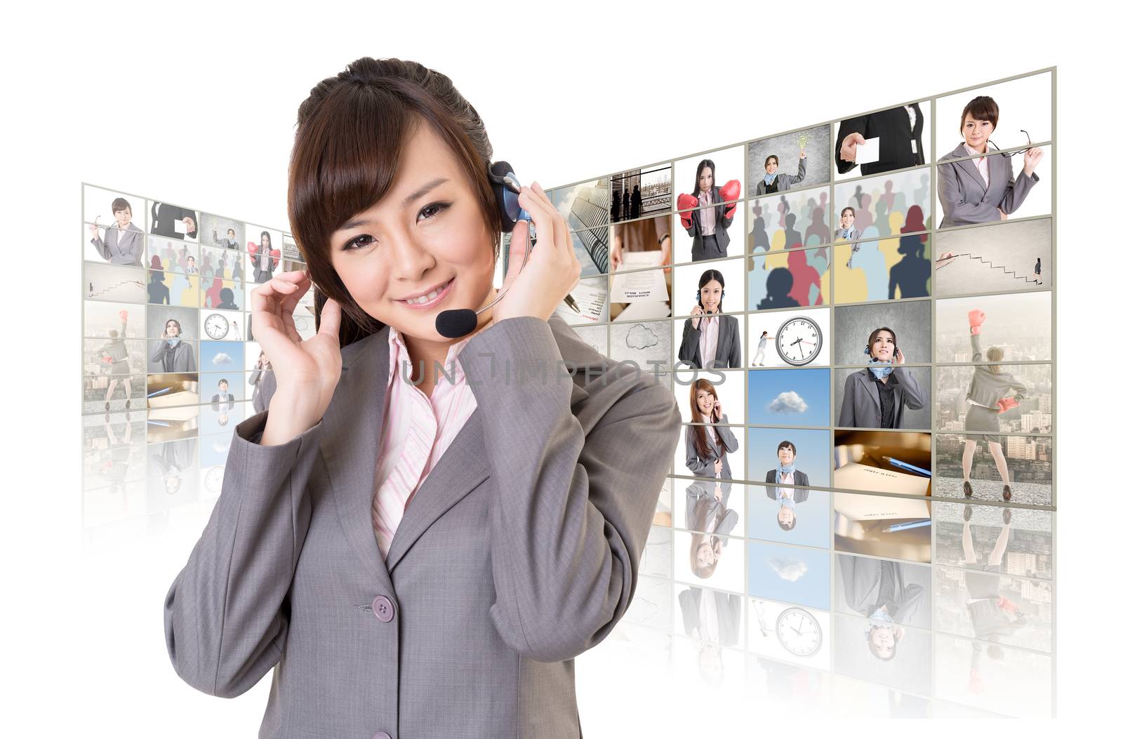 Business woman with headphone standing in front of TV screen wall.