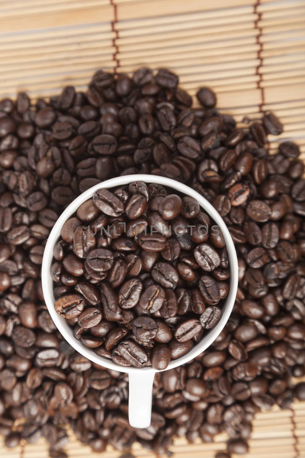 Coffee beans in coffee cup on table wooden.