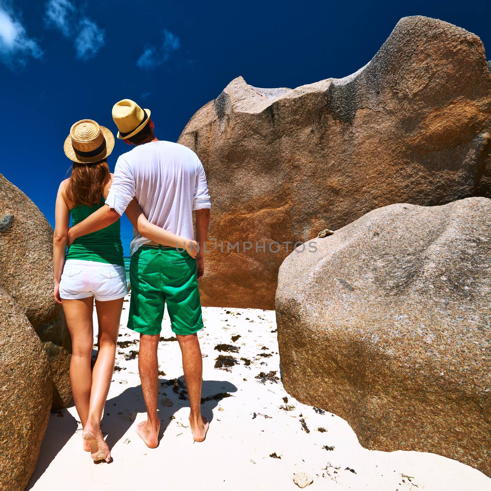 Couple in green on a beach at Seychelles by haveseen