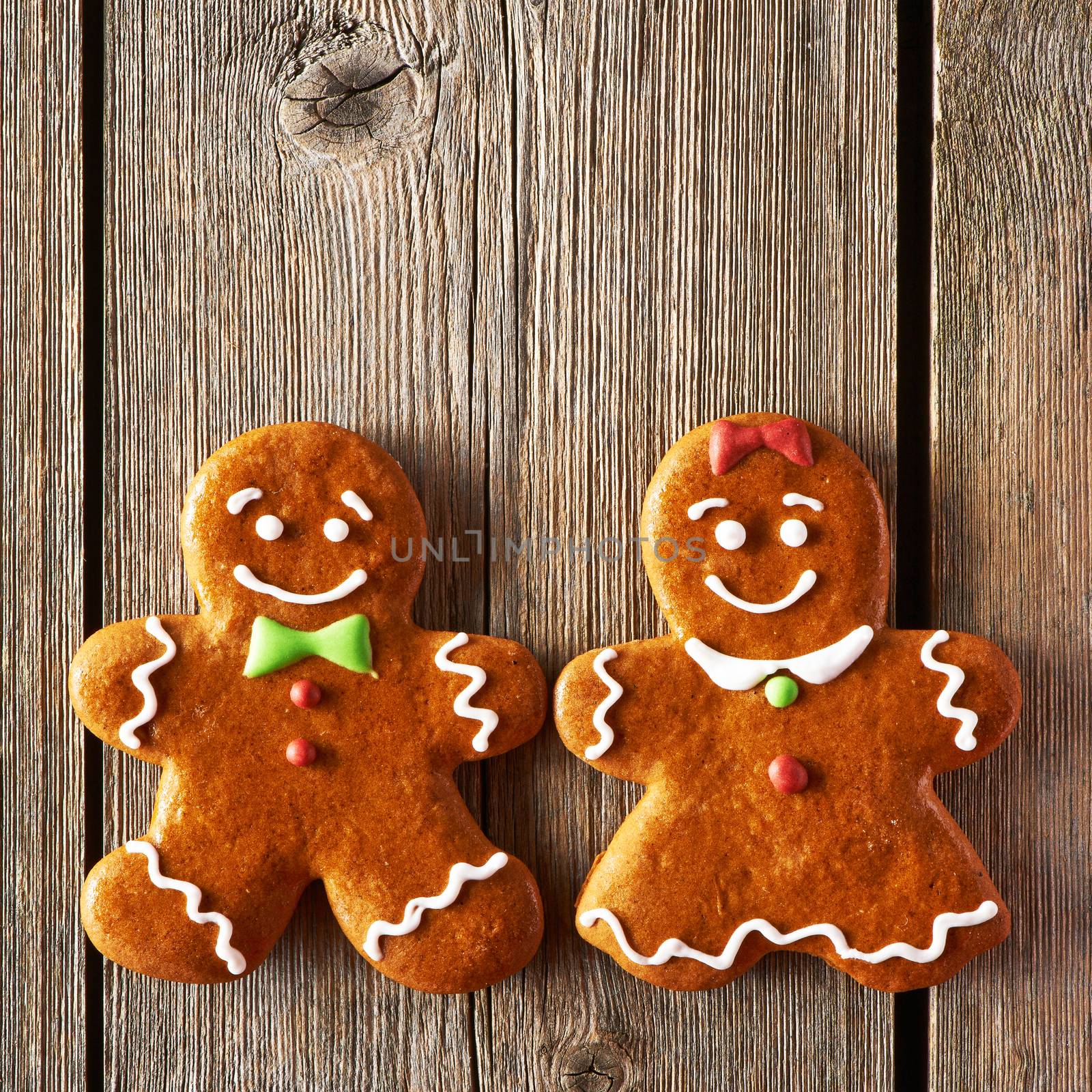 Christmas homemade gingerbread couple cookies on wooden table