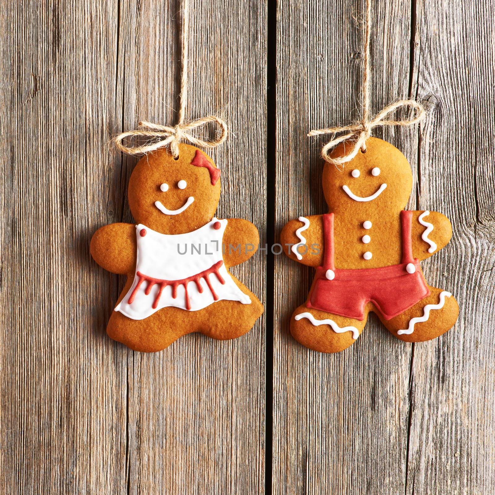 Christmas homemade gingerbread couple cookies over wooden background