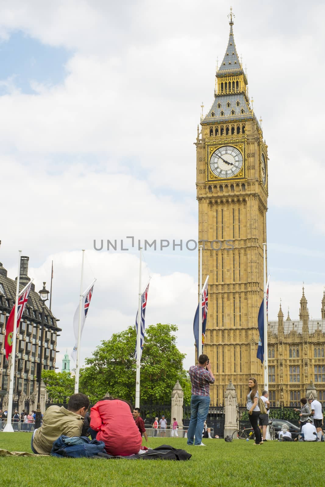LONDON, UK - JUNE 01: Couples in Parliament Square with Big Ben in the background. June 01, 2014 in London.