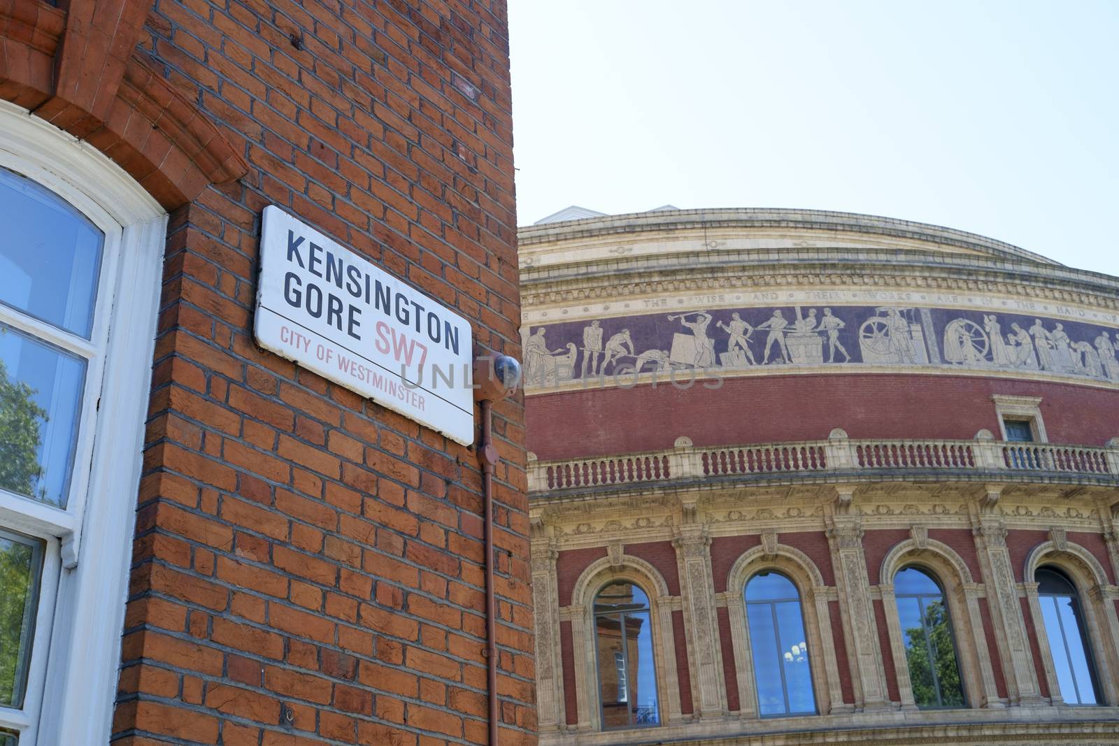 LONDON, UK - AUGUST 11: Kensington Gore street sign with Royal Albert Hall detail in the background. The famous concert house was inaugurated in 1871 by Queen Victoria. August 11, 2014 in London.