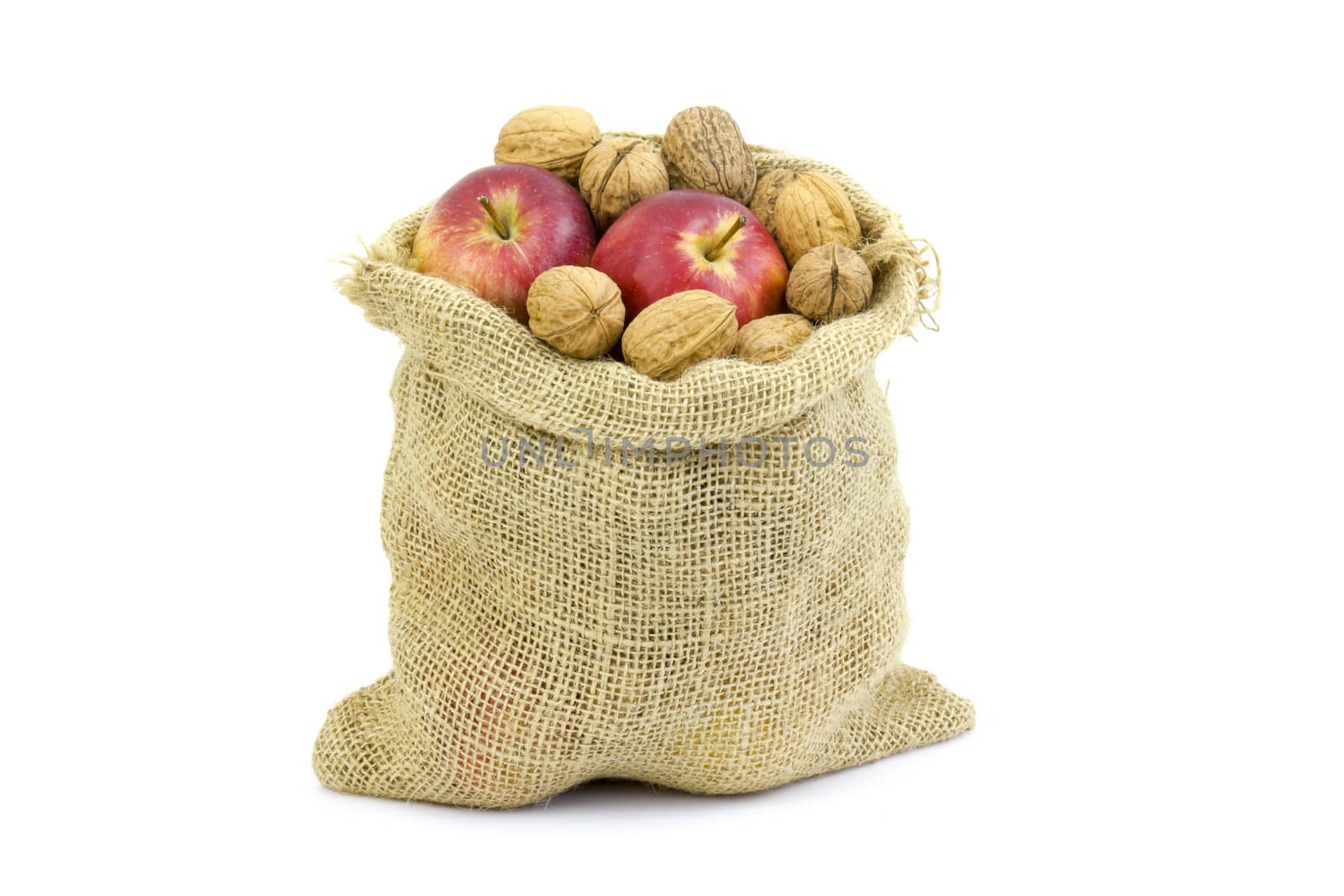Burlap sack full of whole walnuts and apples