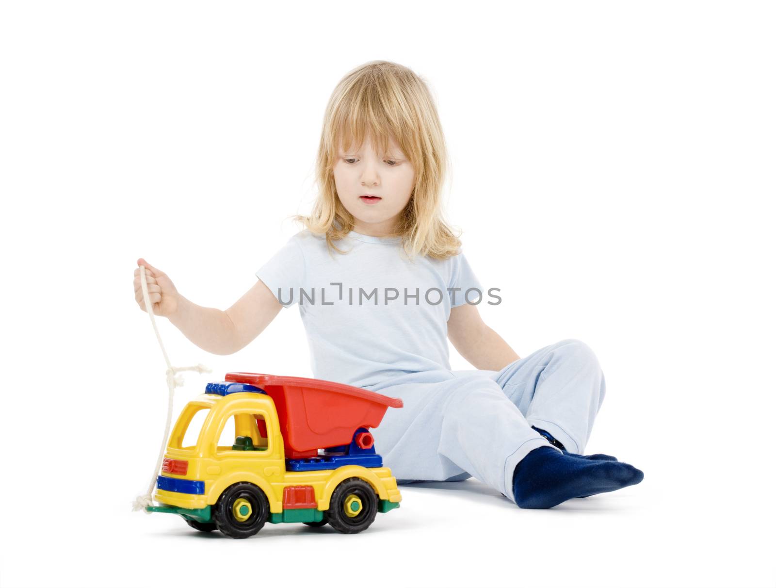 boy playing with toy truck by courtyardpix