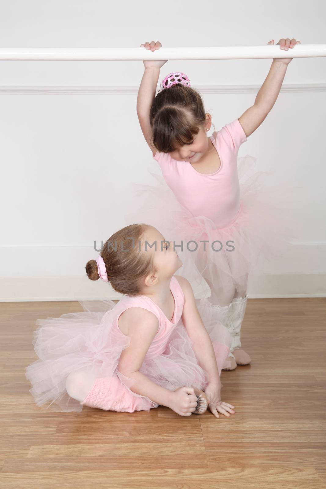 Beautiful little ballet dancers at the dance studio barre