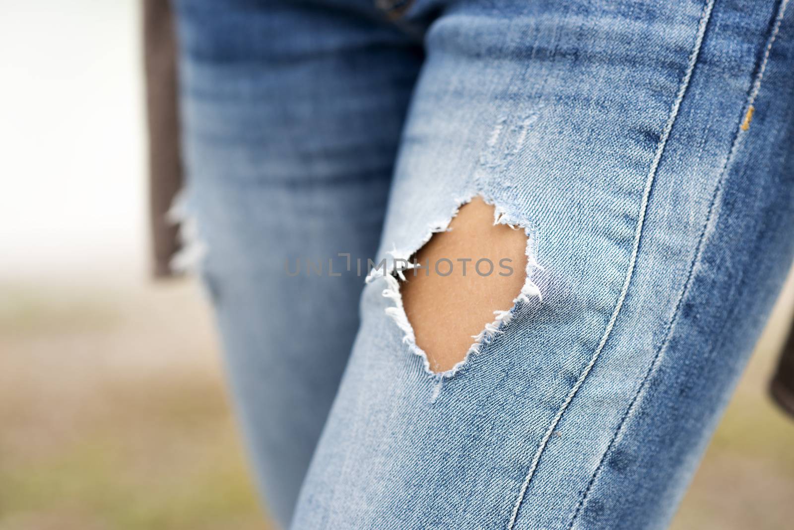 Close up of a torn blue jeans