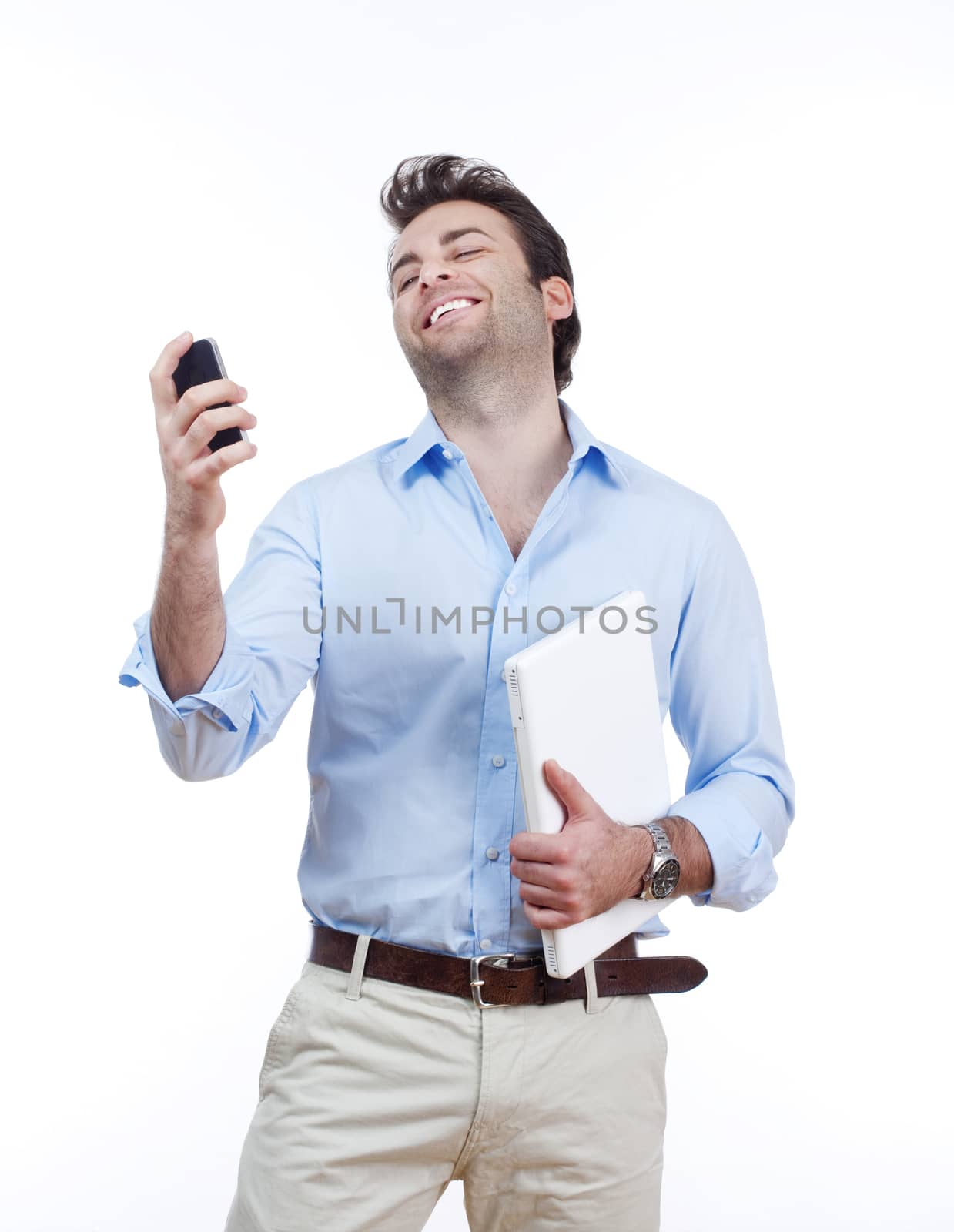 businessman with laptop looking at cellphone, smiling- isolated on white