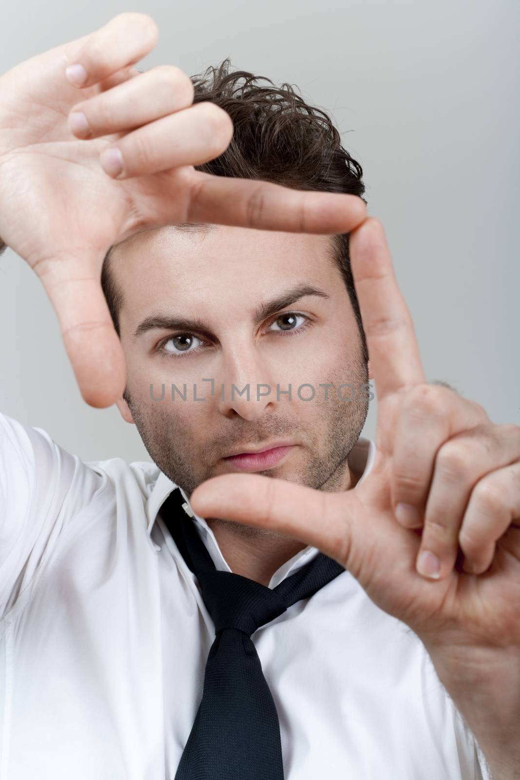 man forming frame with fingers by courtyardpix