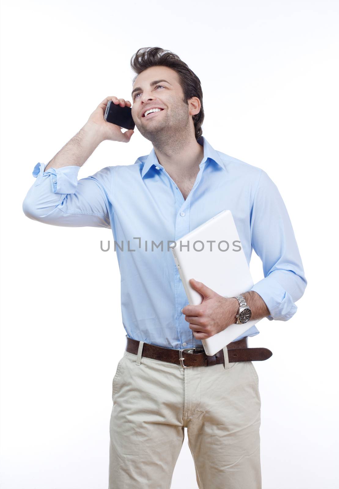 businessman with laptop looking at cellphone, smiling- isolated on white