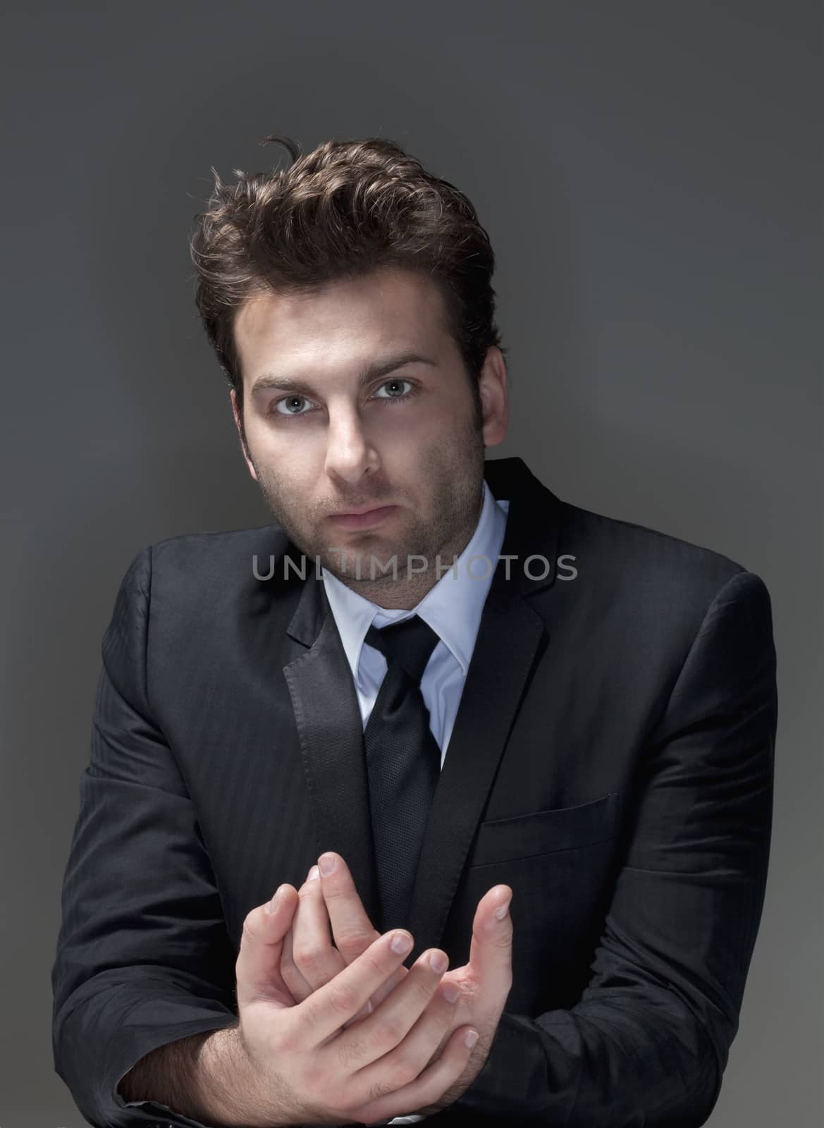 businessman in suit, shirt and tie, concerned, worried - isolated on gray