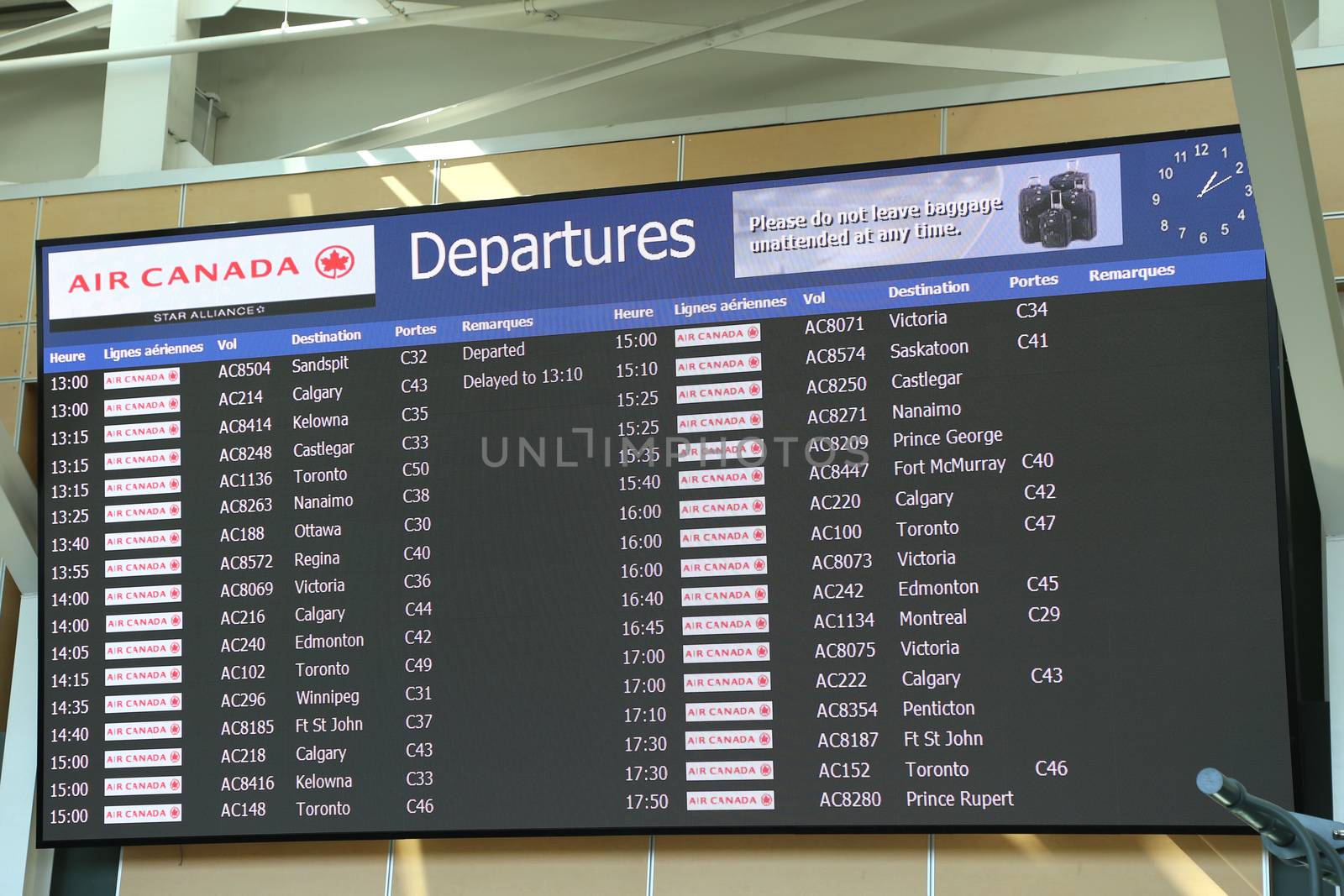 Macro airport departures monitor showing flight gate