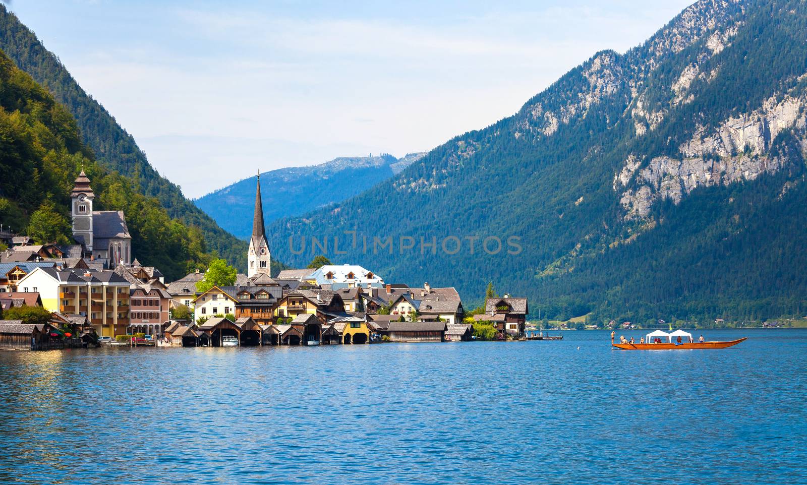 Panoramic view of Hallstatt village with traditional boat on lake, Hallstatt, Austria