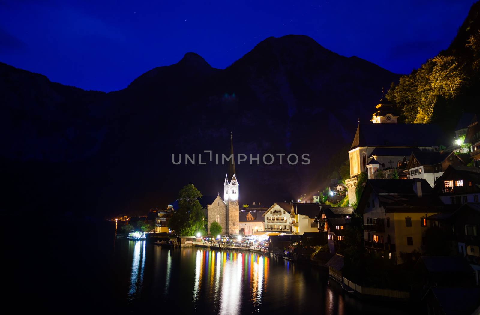 Night view of Hallstatt village with Christuskirche church bell tower, Austria