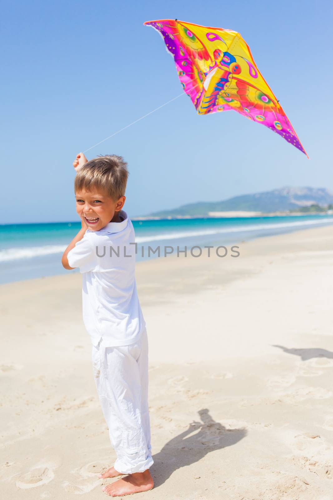 Child flying kite beach outdoor. by maxoliki