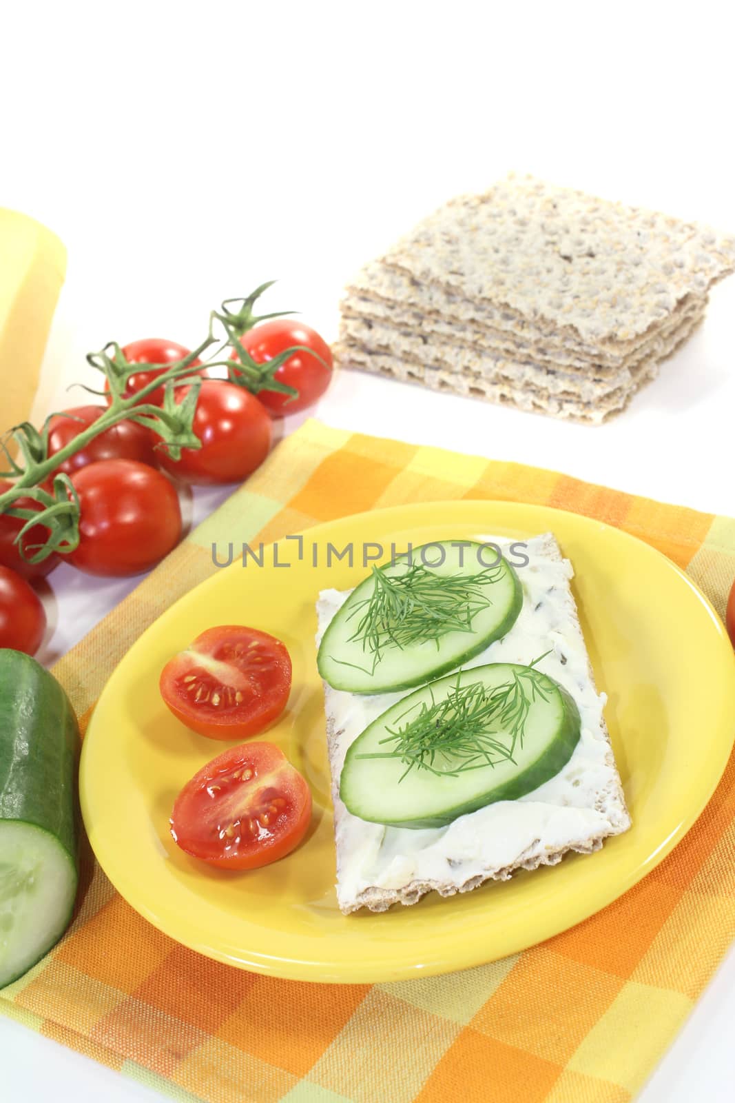 Crispbread with cream cheese and dill on a bright background