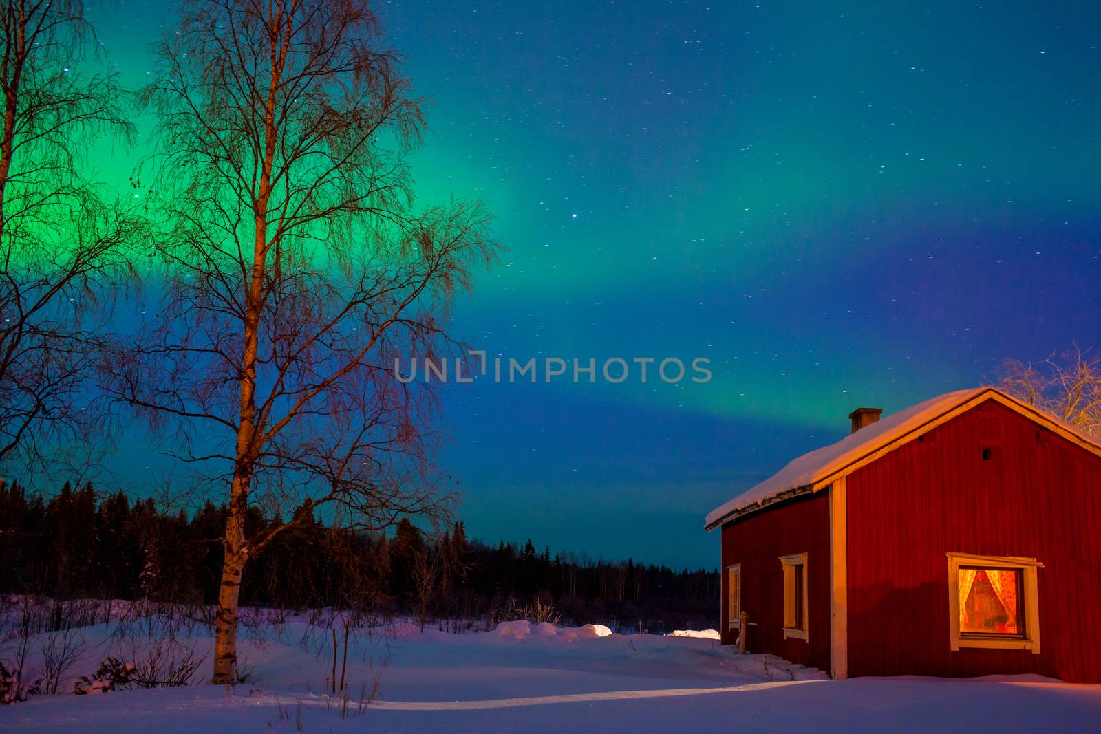 Intense northern lights - Aurora borealis over Lake and red House in Finland