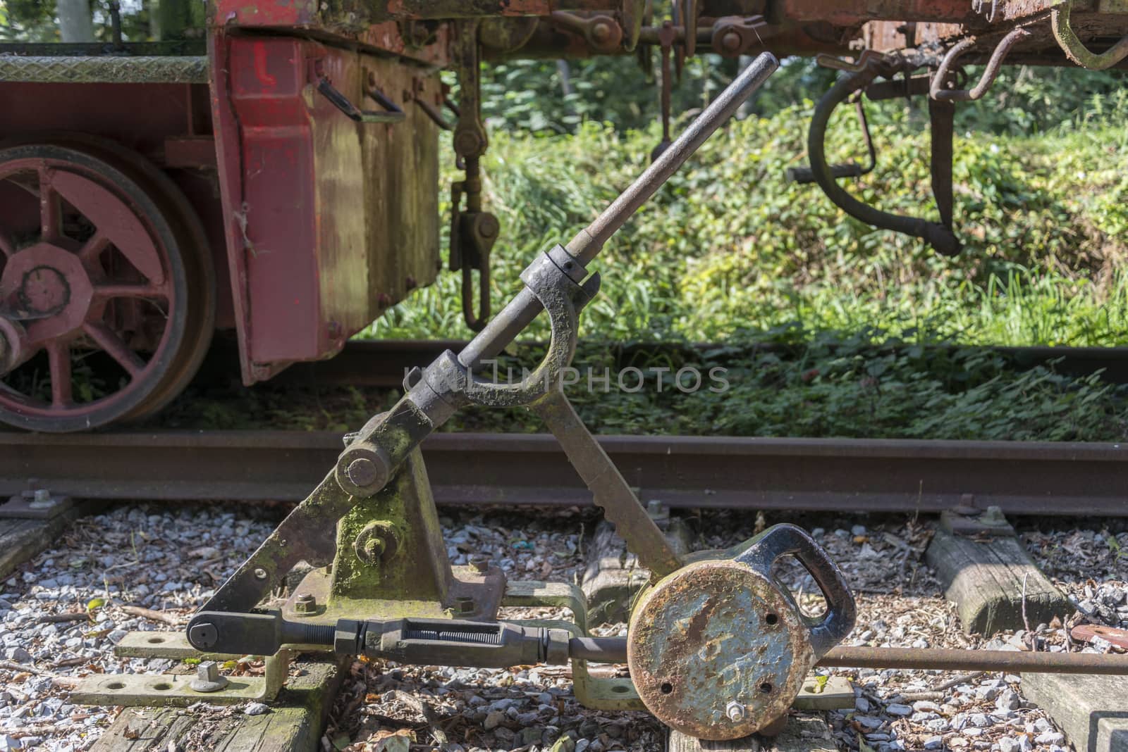 Old railroad track switch with train background