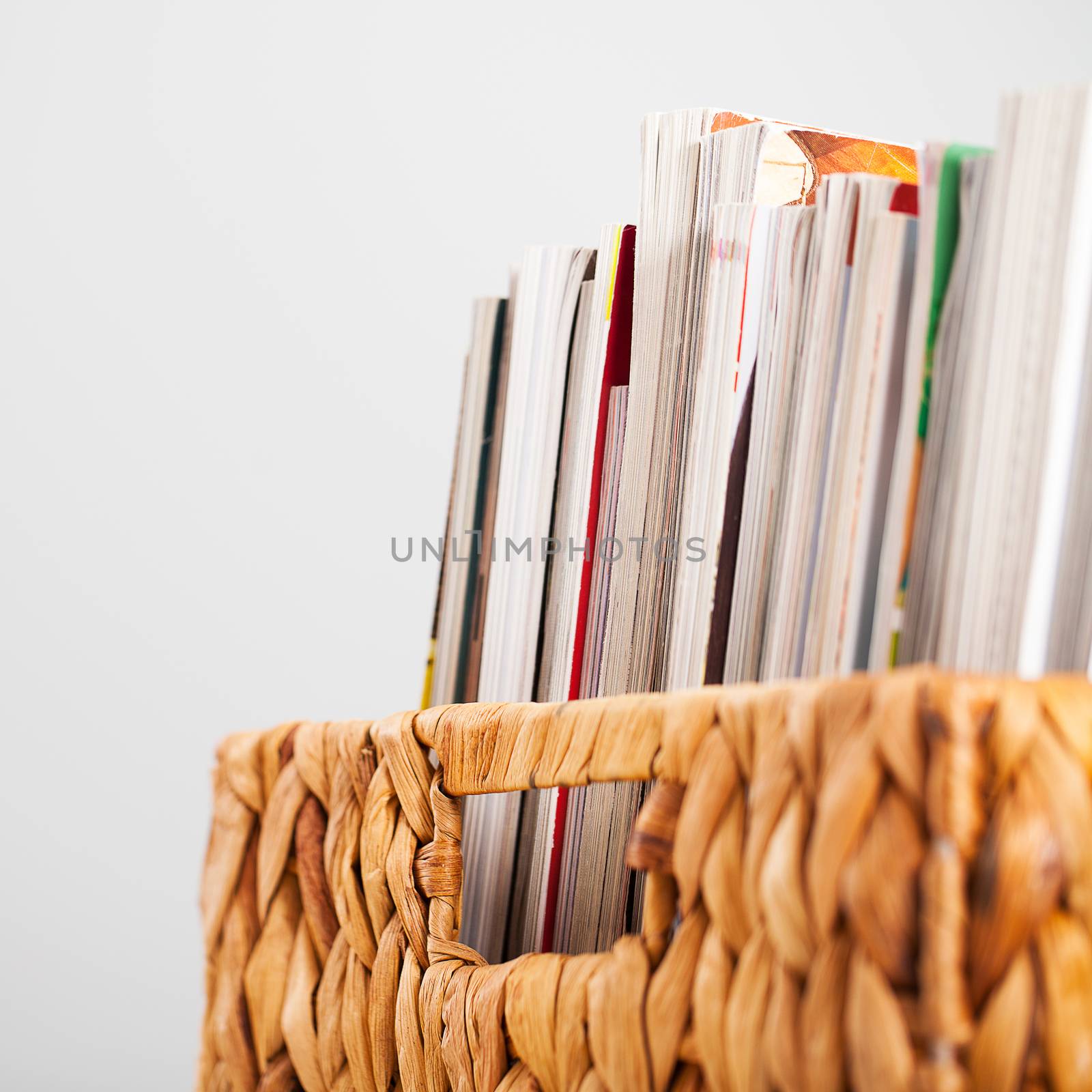Closeup image of magazines in a straw pleated box
