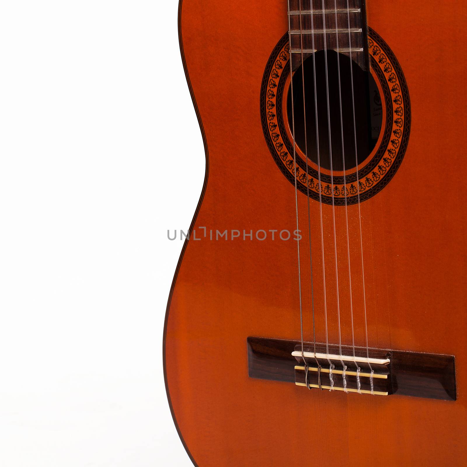 Old wooden brown guitar body over white background
