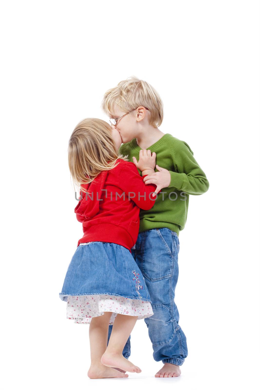 children - brother and sister kissing each other - isolated on white