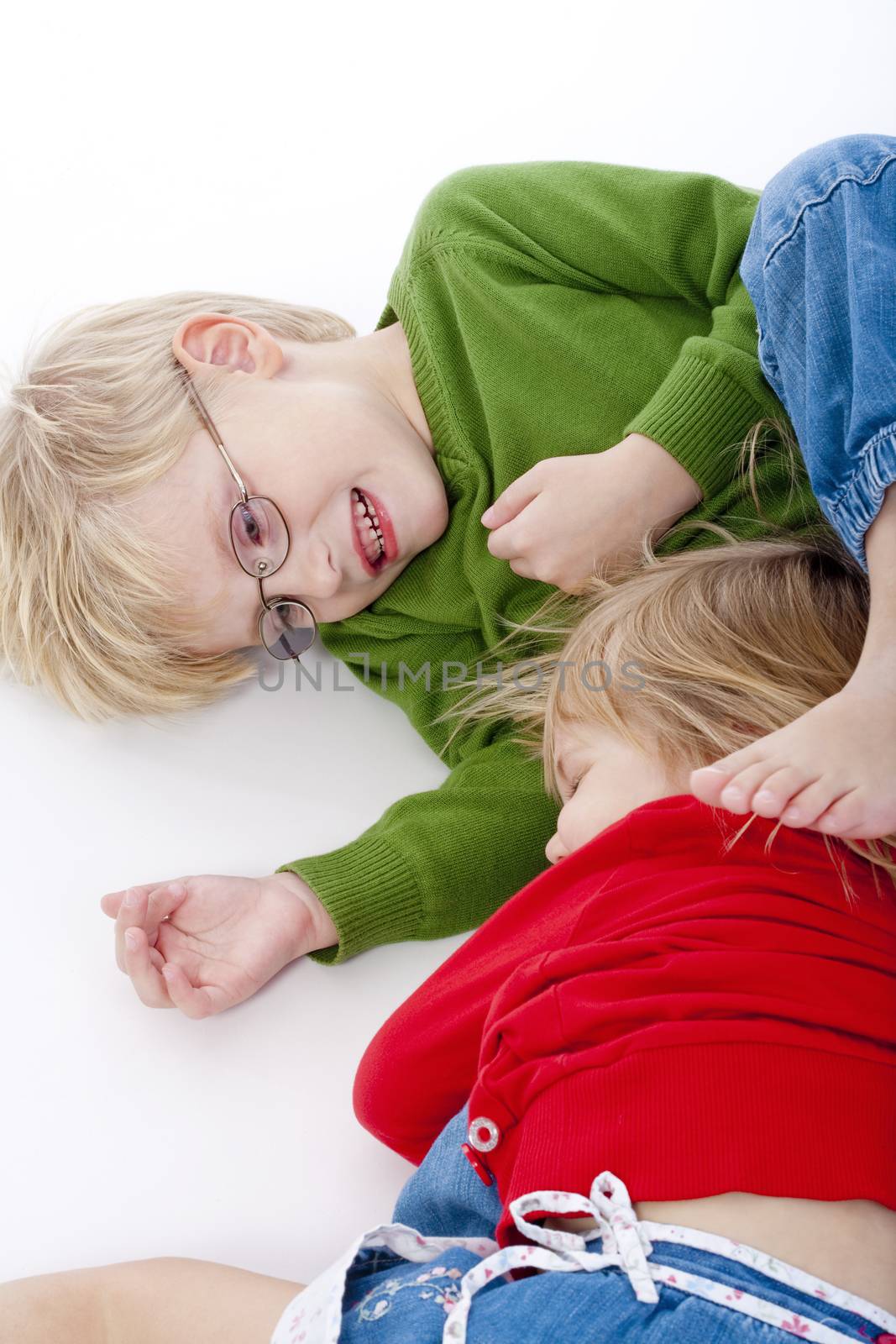 two young siblings fooling around with each other - isolated on white