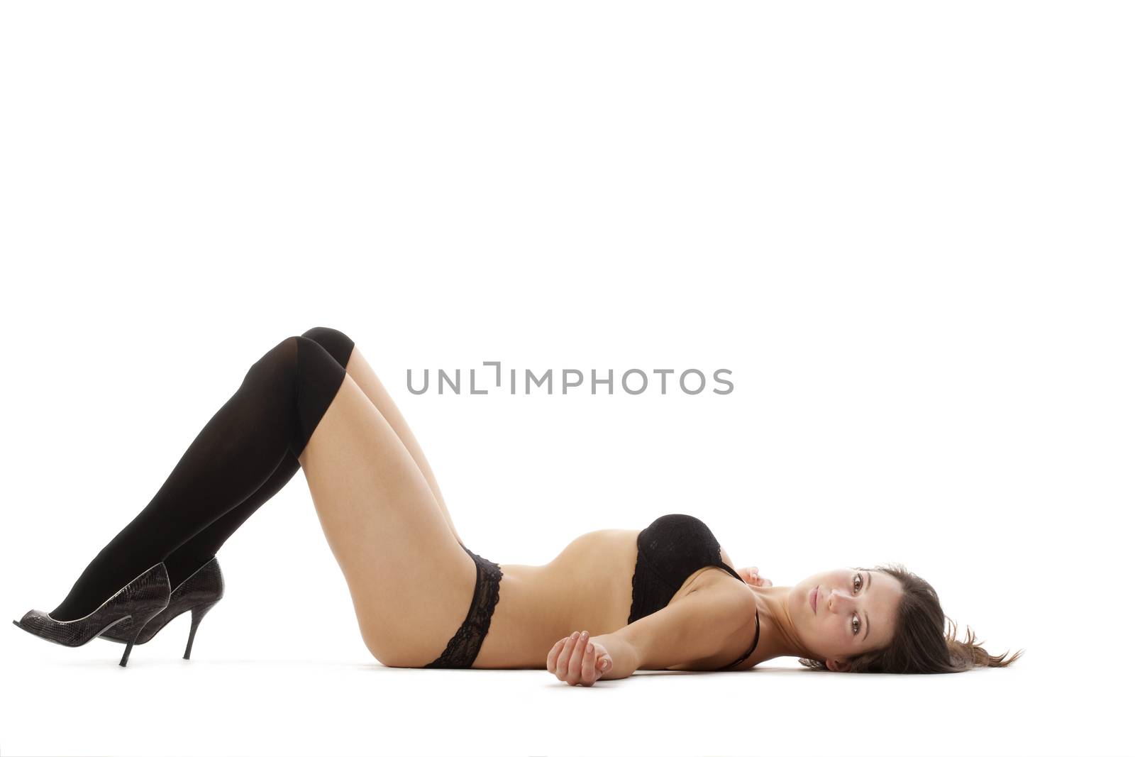 beautiful young woman in black underwear and stockings - isolated on white