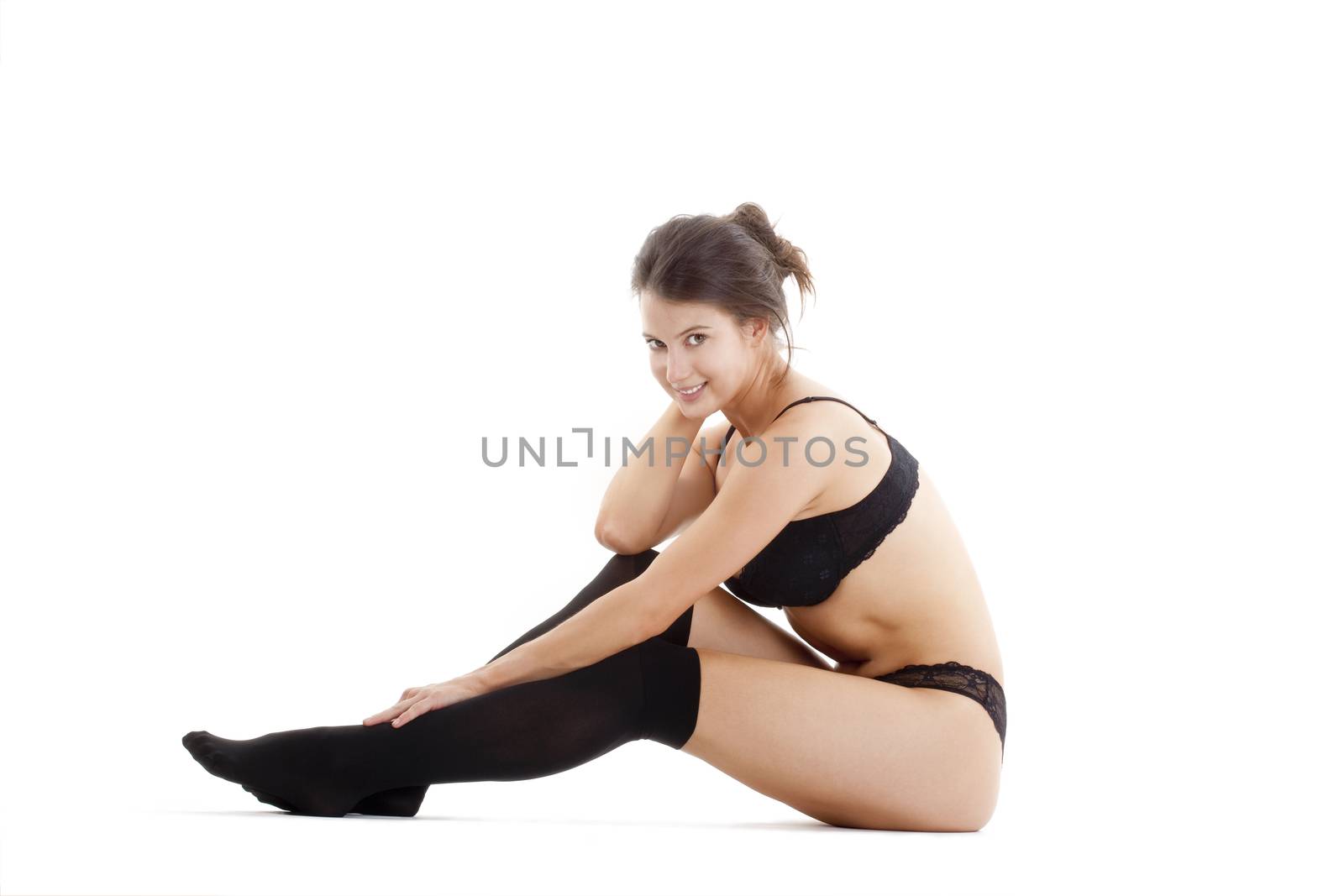 beautiful young woman in black underwear and stockings - isolated on white