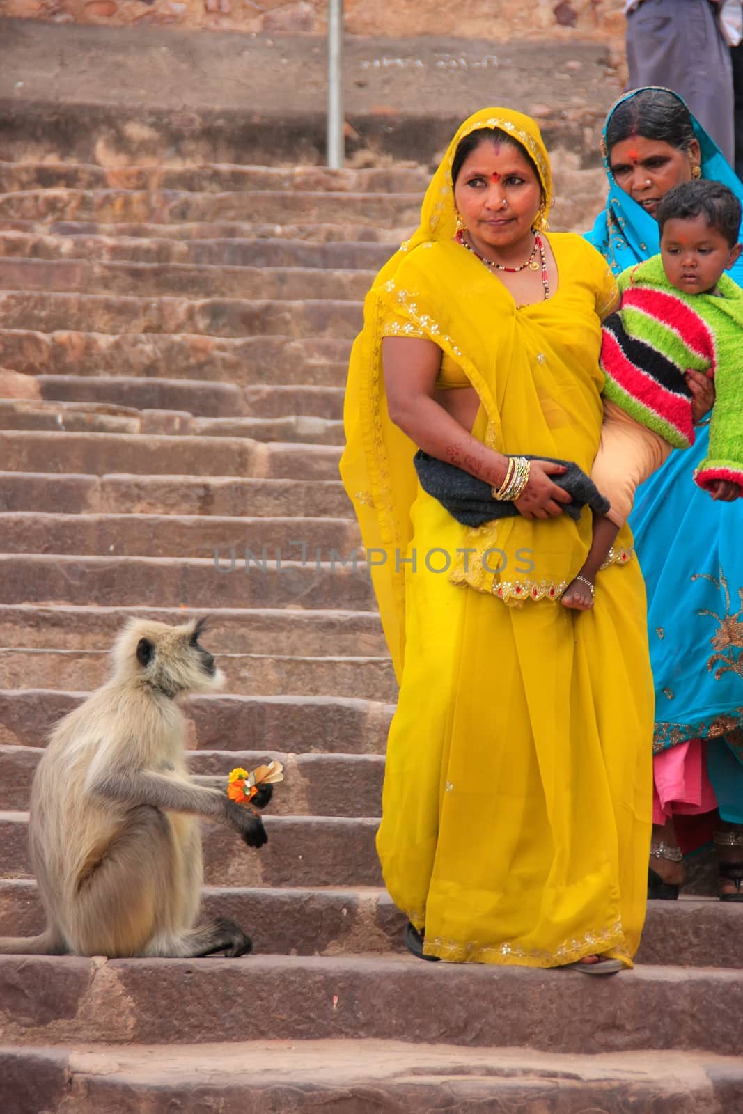 Indian women in colorful sari with a kid walking down the stairs at Ranthambore Fort, Rajasthan, India