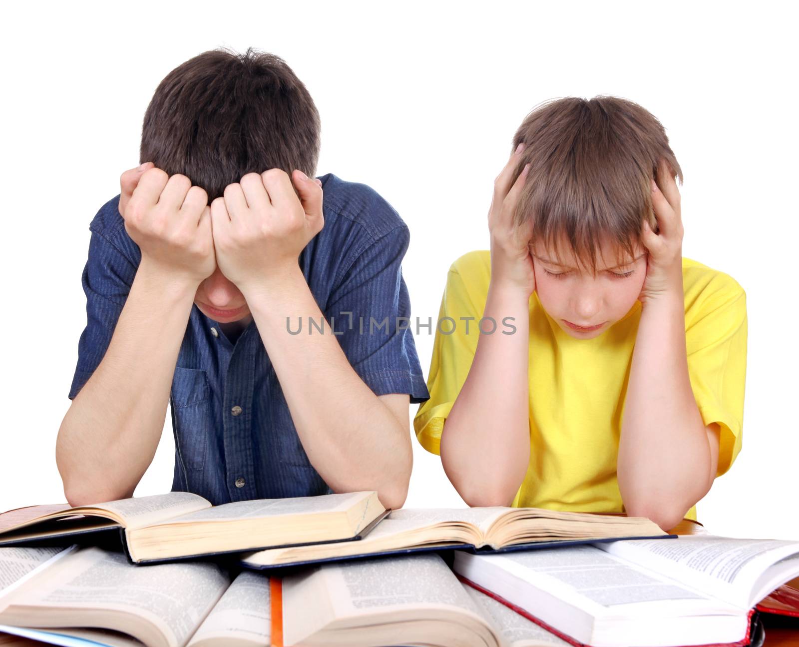 Tired Teenager and Kid at the School Desk on the white background