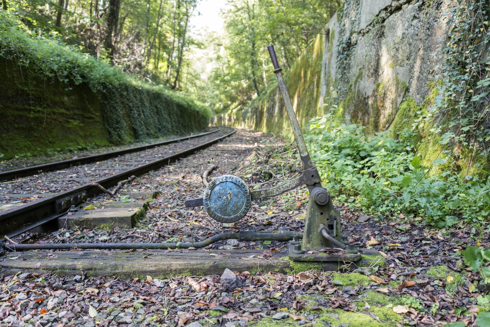 Old railroad track switch with raia as background