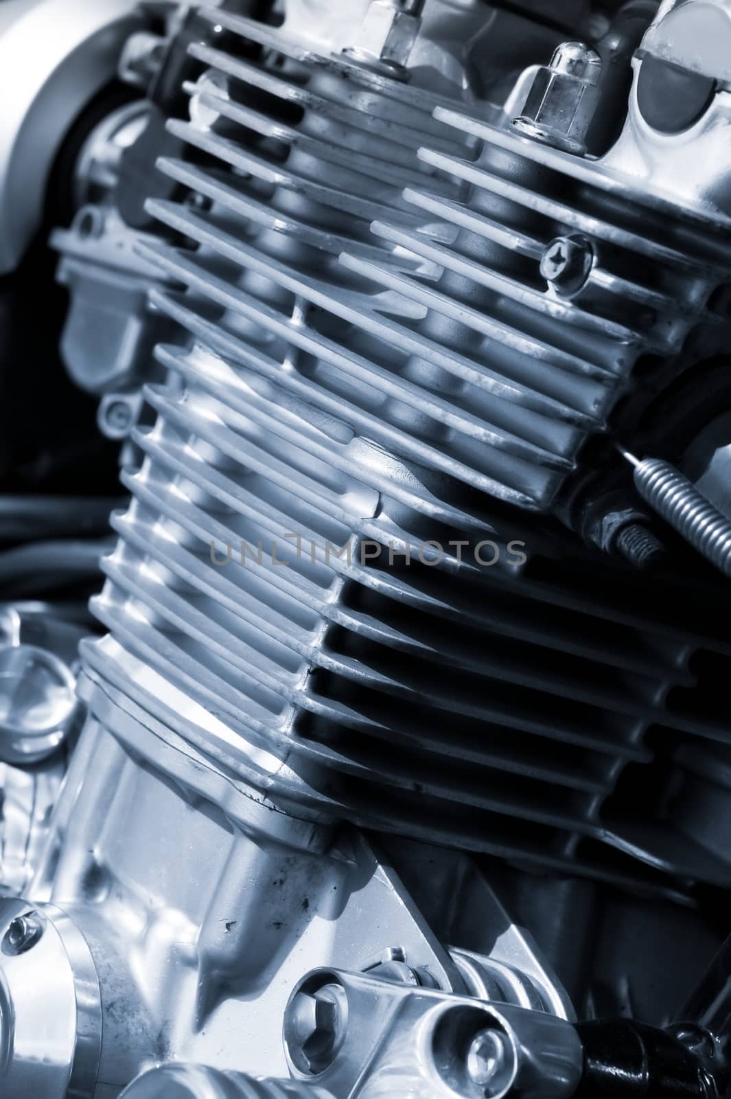 air cooled motorcycle engine detail with a blue tint