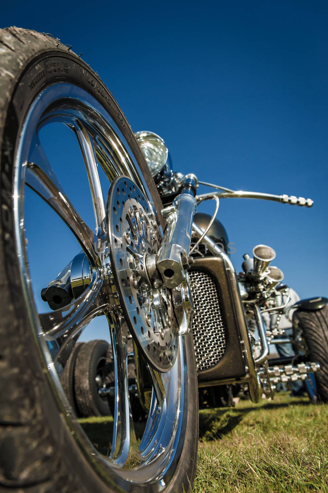chromed motorcycle trike abstract against a blue sky