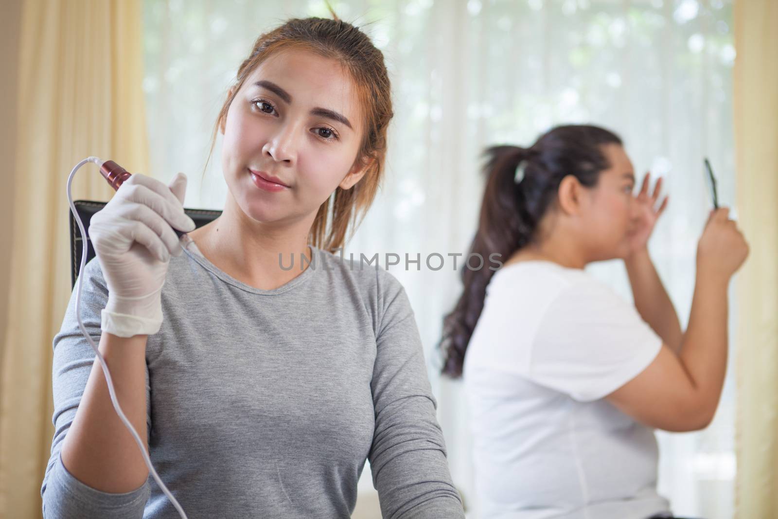 Professional permanent makeup applying on eyebrow