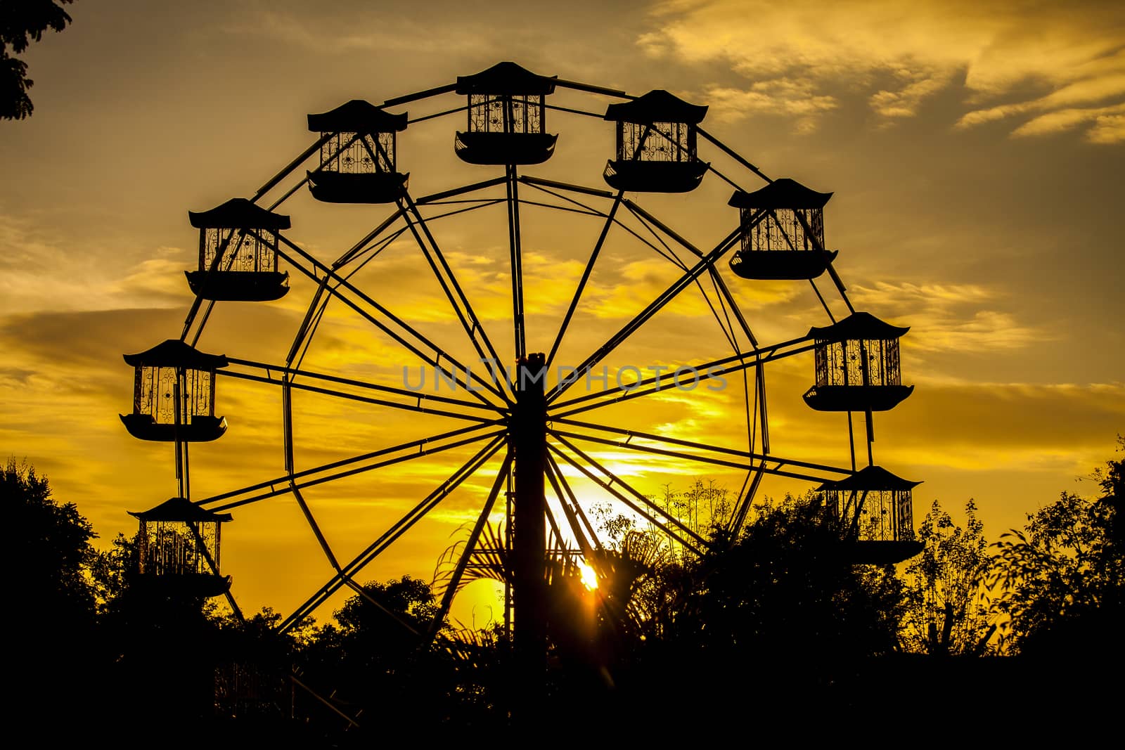 a giant vertical revolving wheel with passenger cars suspended on its outer edge.