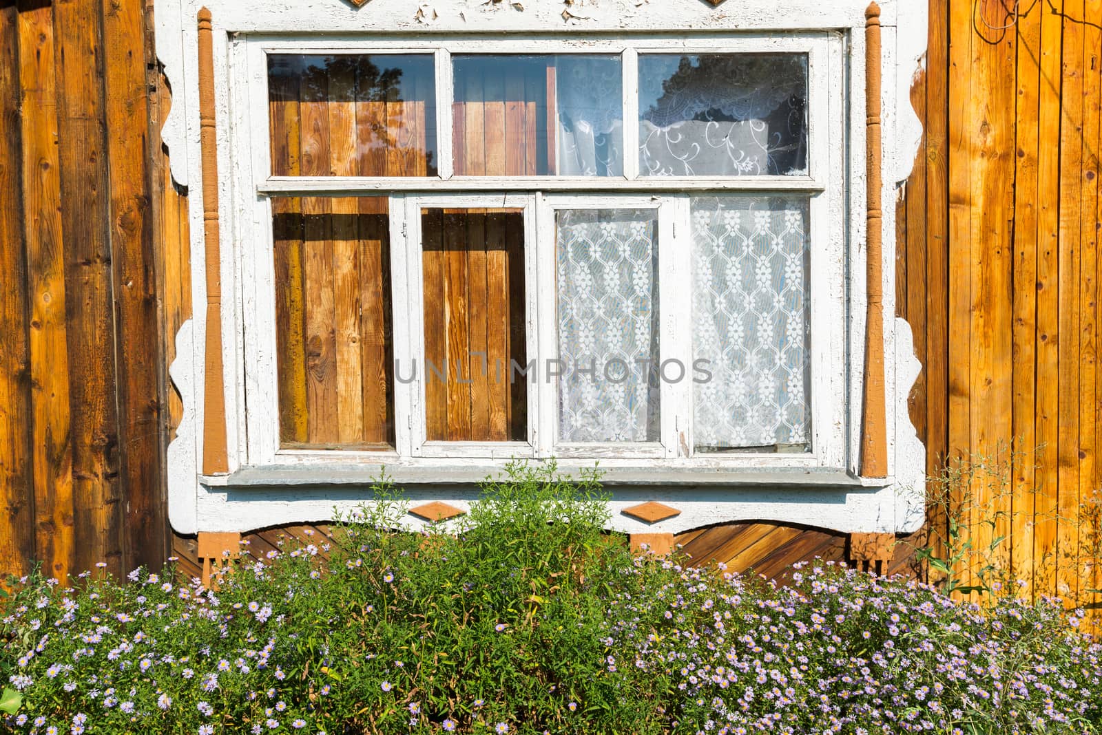 Carved window in old russian wooden country house