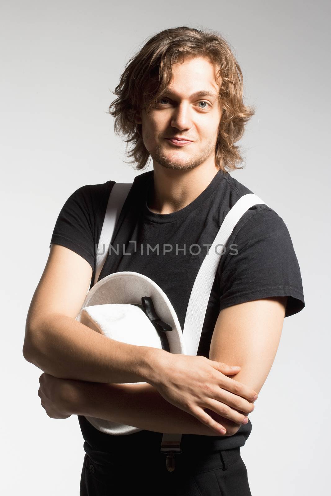 Young Man with Brown Hair Holding a White Hat by courtyardpix